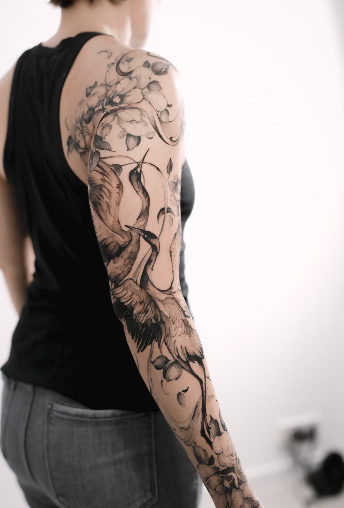 Crane bird and floral tattoo, full arm sleeve
