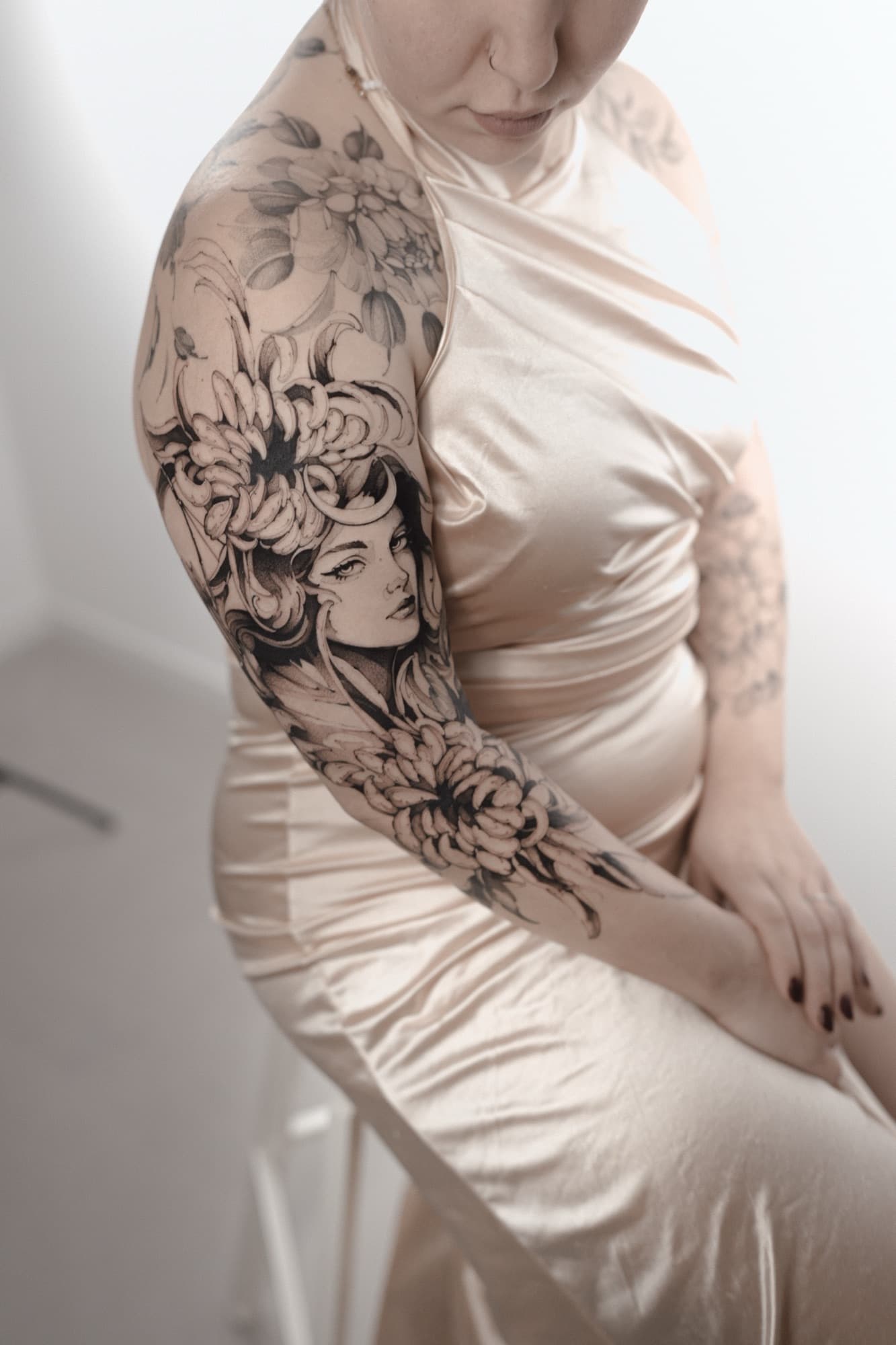 Woman's portrait with chrysanthemum flowers, shoulder sleeve tattoo