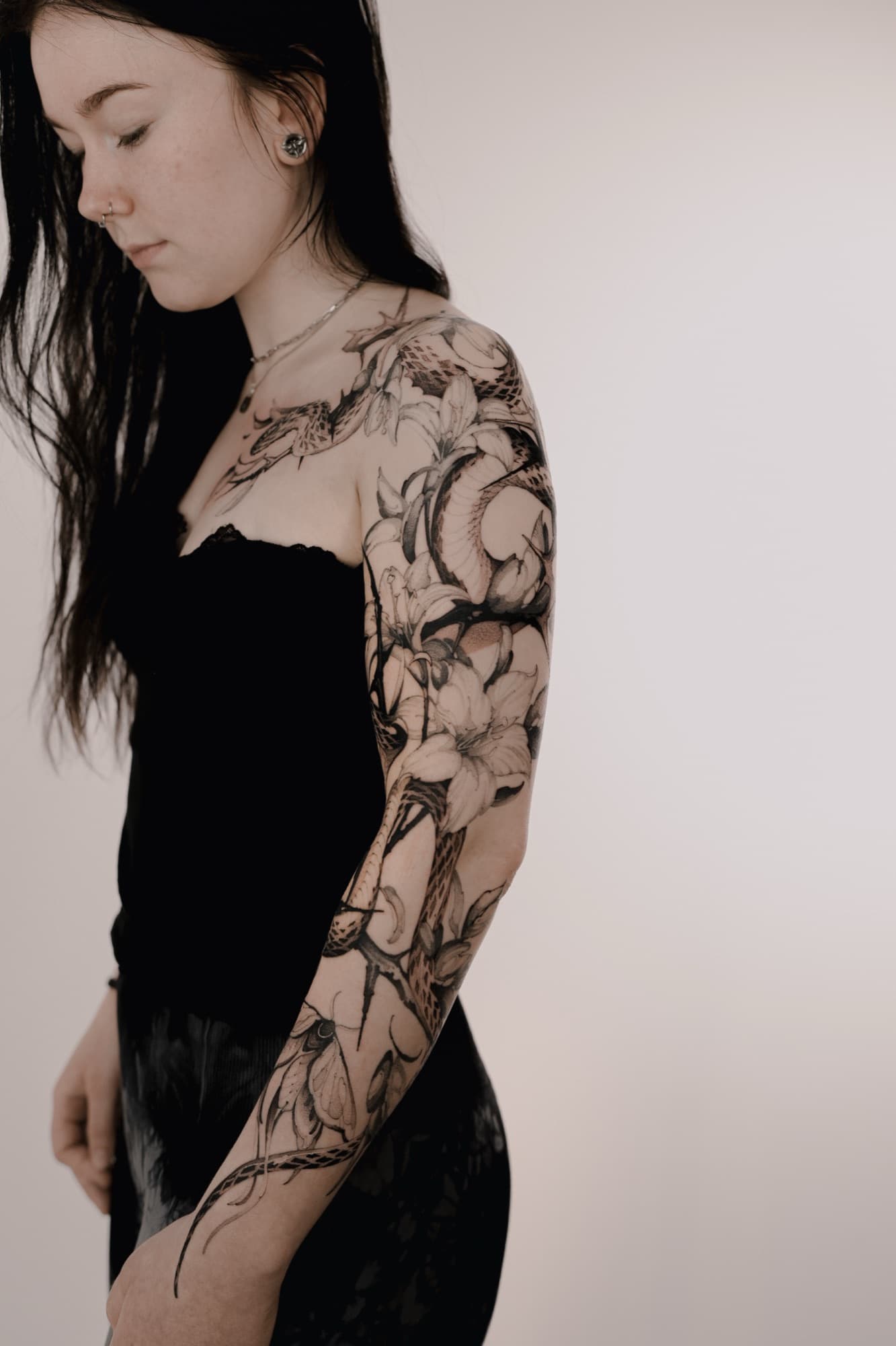 Koi and lily flowers tattoo across the chest and arm